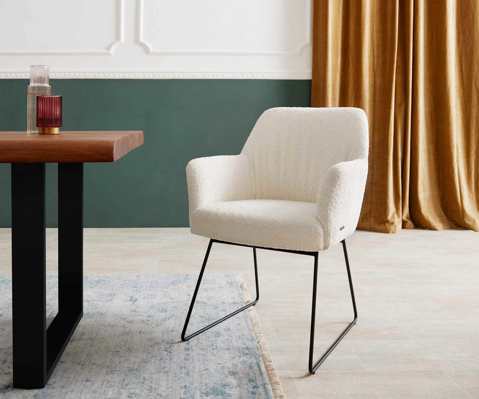 Chaise-de-salle-à-manger Xana-Flex avec accoudoirs bouclé blanc pied trapèze noir ressorts ensachés Chaise-de-salle-à-manger Xana-Flex avec accoudoirs bouclé blanc pied trapèze noir ressorts ensachés